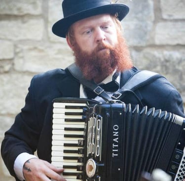 Band member playing accordion during a live performance with Mazel Tov Kocktail Hour