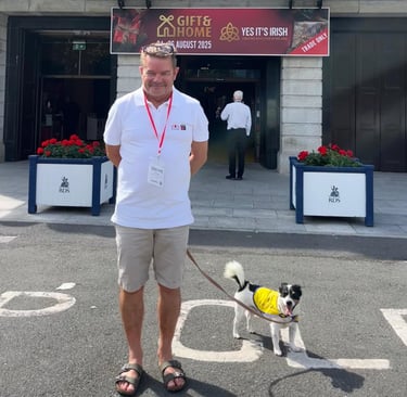 John + Jack the dog standing in doppler gear at the door of the RDS in Dublin for Gift & Home