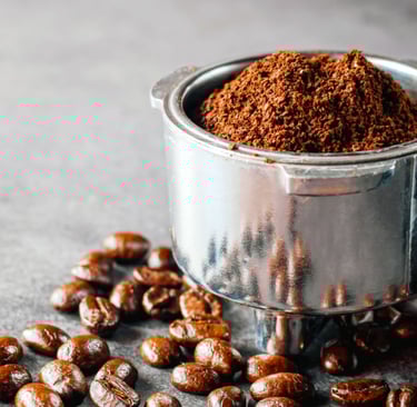 a coffee grinder with coffee beans and coffee beans
