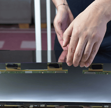 a person holding a laptop computer screen with a laptop on it