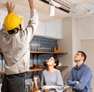 a man and woman standing in a kitchen