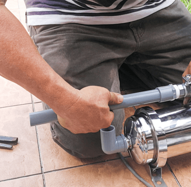 a man is using a pipe cutter to cut a pipe