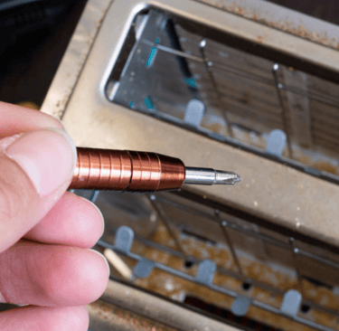 a person holding a pen and writing on a piece of paper