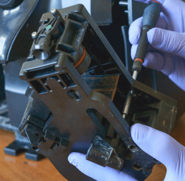 a person in gloves and gloves holding a machine