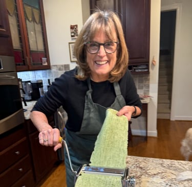 Class participant hand rolling spinach pasta noodle
