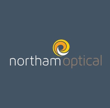 Northam Optical logo with a yellow and white spiral icon above the word "northamoptical" in lowercase white and brown text, s