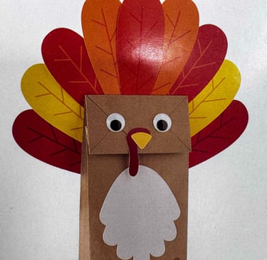 A craft class of a brown paper bag made into a turkey