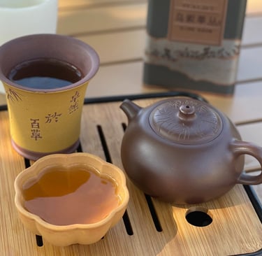 teacup and teapot placed on a wooden tray