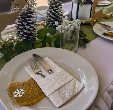 a table setting with pine cones and pine cones