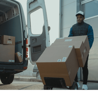 a man is moving boxes of boxes into a van