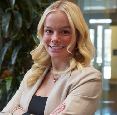 Formal headshot of Whitney with clean lighting and a poised, professional look.
