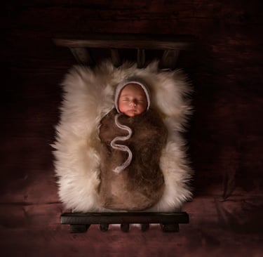 a baby in a blanket wrapped in a blanket