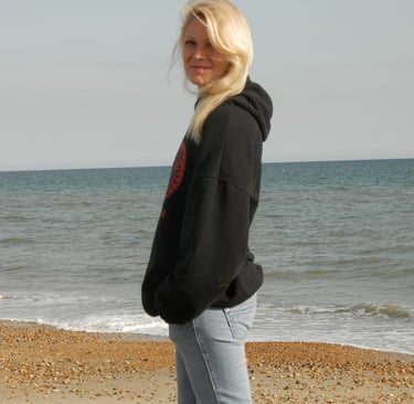 a artist woman standing on a beach 
