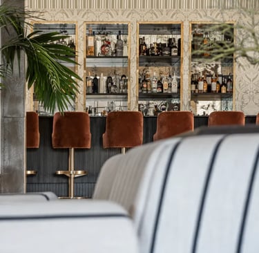 Cocktail bar at Villa La Gratitud with custom cabinetry and velvet seating