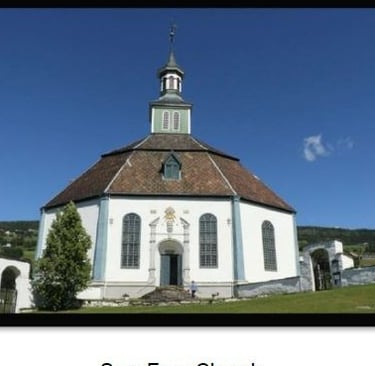 an octagonal white church with a steeple