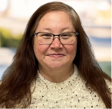 a woman with glasses and a sweater on