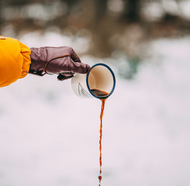 pouring a cup of coffee in the snow
