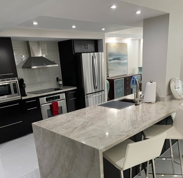 a kitchen with a marble counter top and chairs