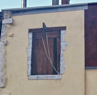 Fenêtre d'atelier peinte en trompe-l'oeil sur une façade à Moirans-en-Montagne dans le Jura, 39.