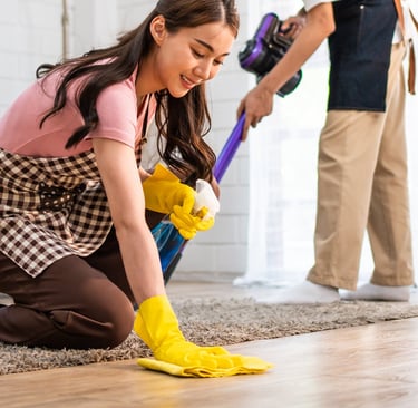 a man and woman cleaning a living room