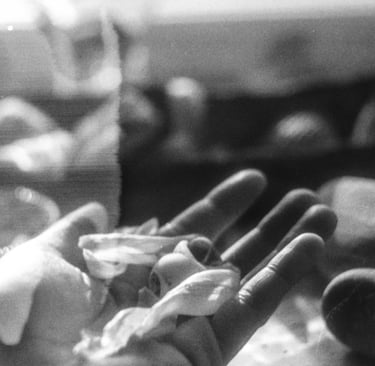 a hand holding delicate matter, being inspected and measured