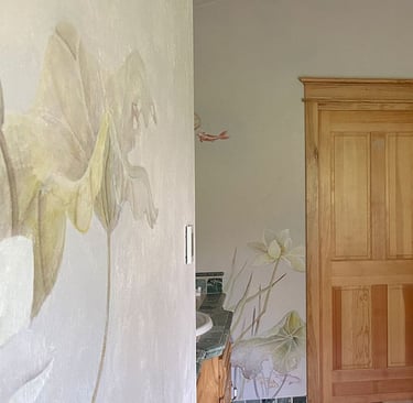 Luxury bathroom featuring painted murals of water lilies, koi and dragonflies in  watercolour and an Asian touch