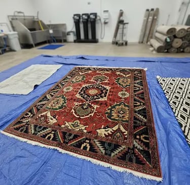 Oriental Wool Rug being prepped in a rug washing bay.