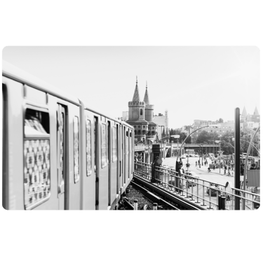 a train on a train track with a clock tower in the background