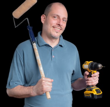 Portrait of Cyd holding a paint roller and a drill
