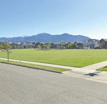a street scene with a street sign and a car parked on the side of the