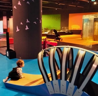 a child's play area with a large chair and a large chair
