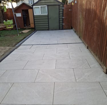 a patio with a concrete patio with a wooden fence