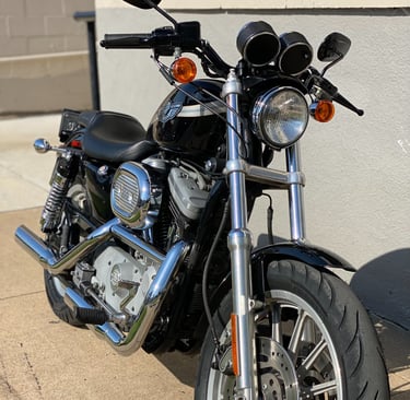 a motorcycle parked next to a building with a motorcycle