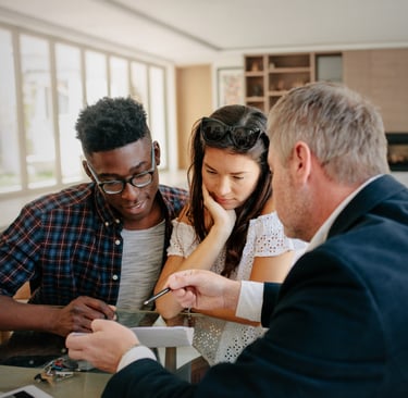 Professional real estate agent explaining interest rates to new home buyers