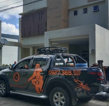 Professional termite control service truck parked in front of a modern residential home.