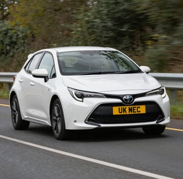A professional PCO licensed black car waiting outside a city hotel for a taxi service.
