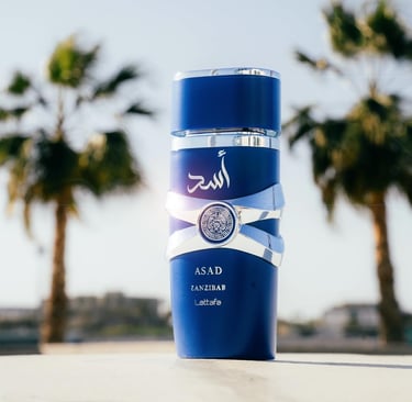 Lattafa Asad Zanzibar blue perfume bottle displayed outdoors with tropical palm trees.