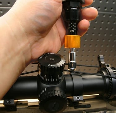 Image link of tightening a screw on a scope ring linking to a blog post about torque specs