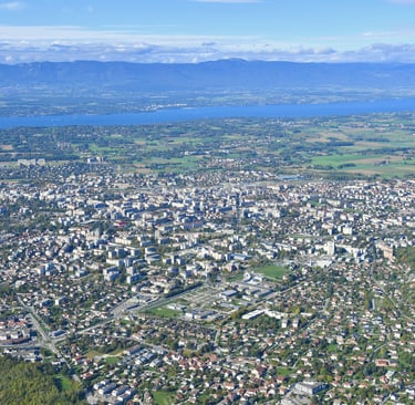 a cityscape of a city with a lake in the background