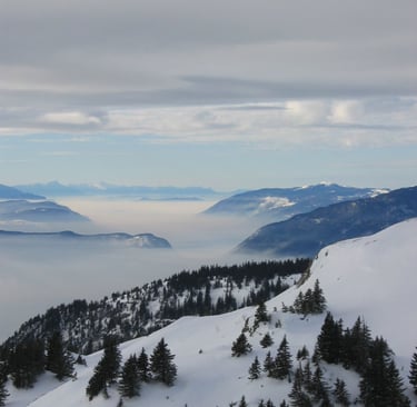 a person on a ski slope with a view of the mountains