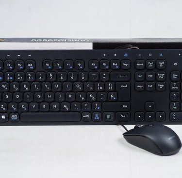 Black wired full-size keyboard and optical mouse set with round keys and number pad.
