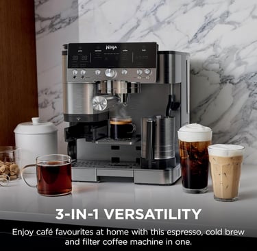 Ninja 3-in-1 espresso, cold brew, and filter coffee machine on a marble countertop with various cafe drinks.