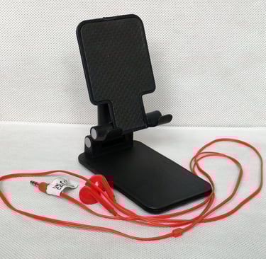 Desk phone holder, foldable, with a red, wired earphones, to make the sessions more comfortable