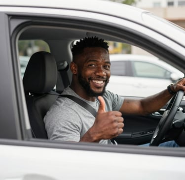 An Uber driver smiling inside a clean, spacious rental car parked beside a busy city street.