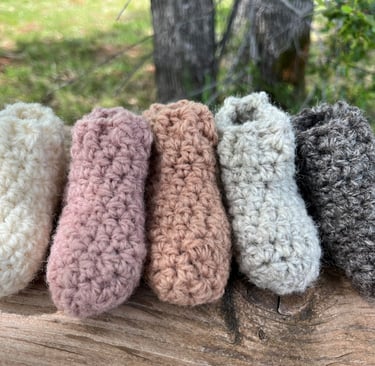 a group of knitted slippers with a variety of different colors