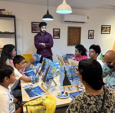 A group of people attending a painting workshop, creating Van Gogh inspired starry nigh on canvases.