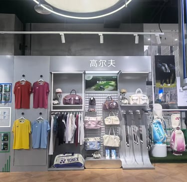 A wall display in a sports store featuring a wide variety of Yonex badminton rackets and athletic apparel.