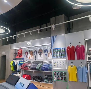 Yonex retail store interior displaying tennis racquets, sports apparel, and gear on wall racks.