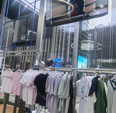 Yonex sportswear and tennis apparel displayed on a clothing rack in a modern retail store.