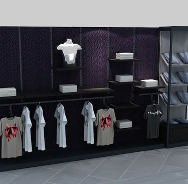 Modern retail clothing display featuring t-shirts on hangers, folded apparel, and a silver mannequin torso.